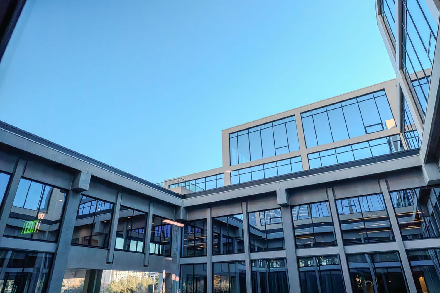Glass atrium and structural facade against open sky